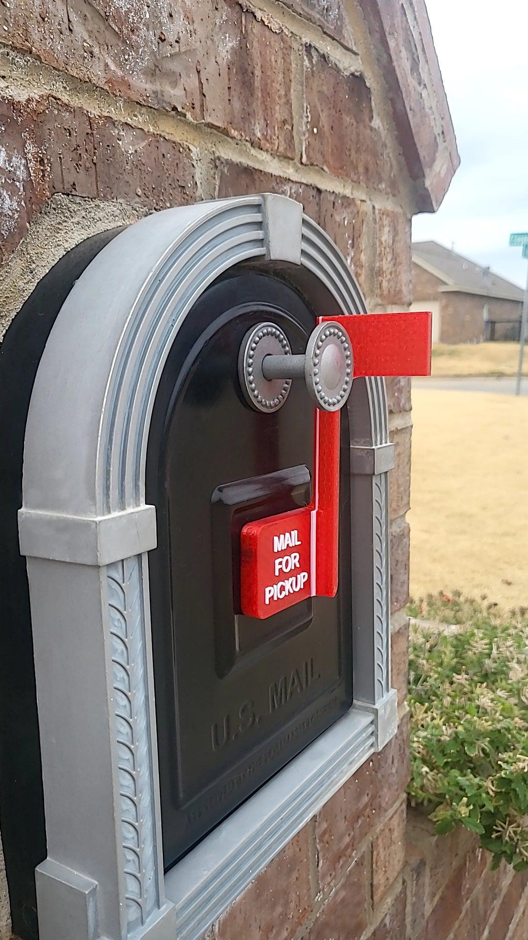 A brick mailbox with a red flag and a label reading 'Mail for Pickup.'