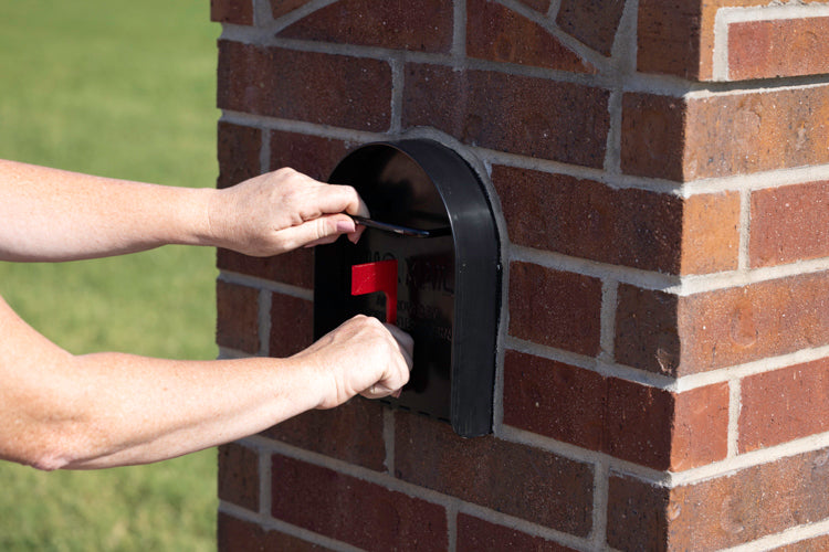 Red flag on the front of a black mailbox